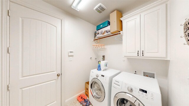washroom featuring cabinet space, separate washer and dryer, baseboards, and visible vents