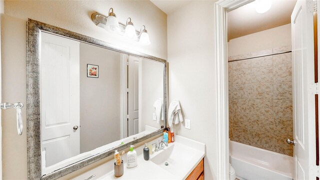 bathroom with vanity, toilet, and tub / shower combination