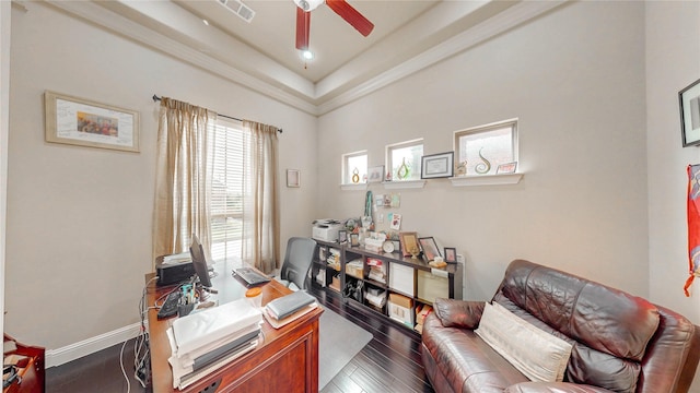 office with visible vents, a ceiling fan, baseboards, and wood finished floors
