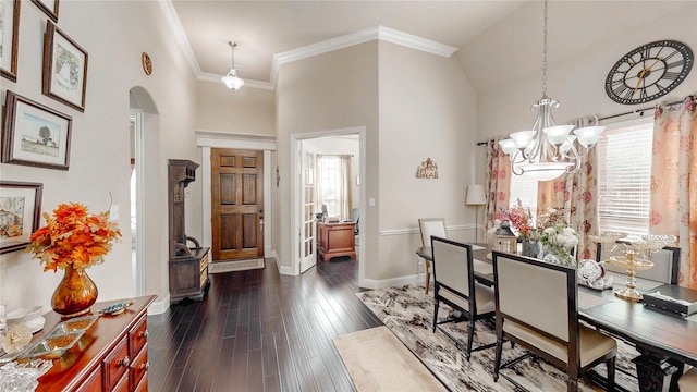 dining space featuring arched walkways, a towering ceiling, a chandelier, and dark wood-style floors