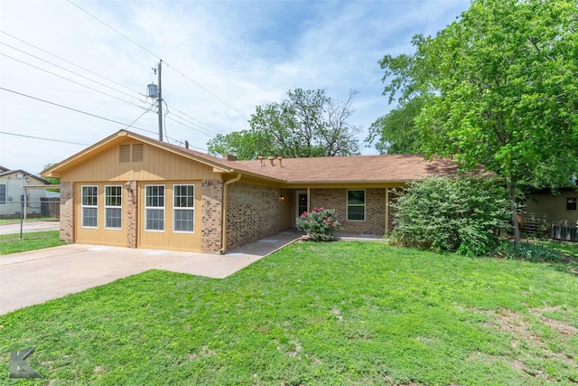 single story home with concrete driveway, brick siding, fence, and a front lawn