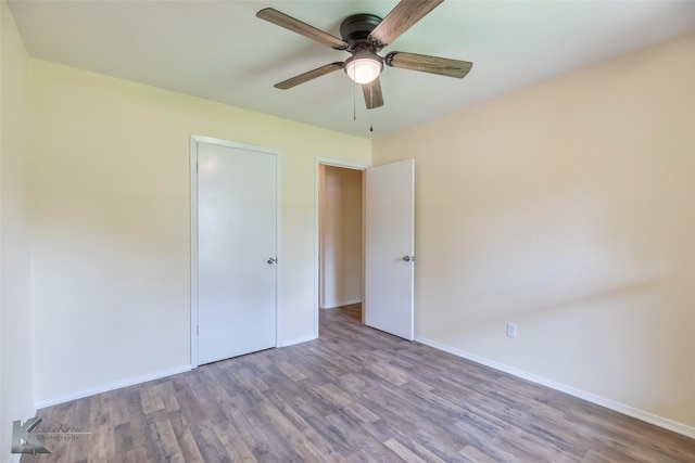 unfurnished bedroom with baseboards, a ceiling fan, and wood finished floors
