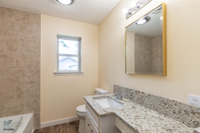bathroom featuring vanity, baseboards, toilet, and wood finished floors