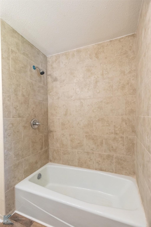 full bath with a textured ceiling