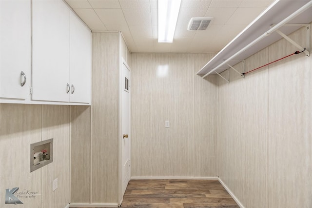 laundry room featuring cabinet space, washer hookup, visible vents, and wood finished floors