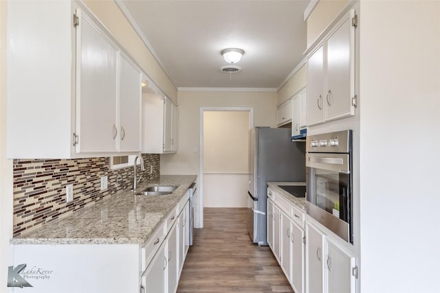 kitchen with a sink, white cabinetry, and stainless steel appliances