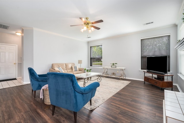 living area featuring visible vents, baseboards, ceiling fan, and wood finished floors