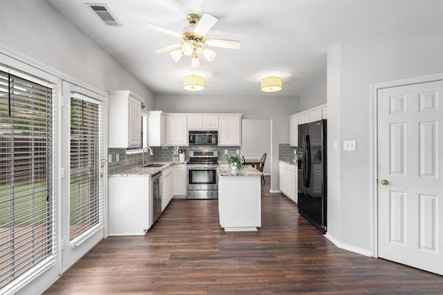 kitchen featuring a sink, tasteful backsplash, black appliances, and visible vents