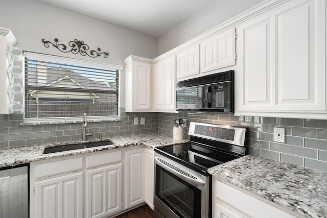 kitchen with a sink, white cabinets, tasteful backsplash, and stainless steel appliances