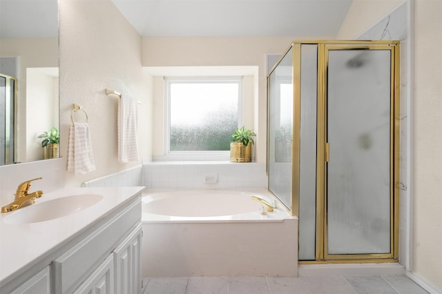 full bathroom featuring vanity, a garden tub, and a stall shower
