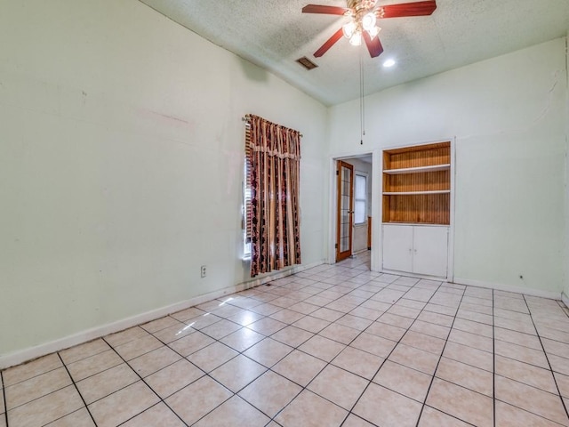 4942 Terry St, Dallas, TX 75223 - empty room featuring a ceiling fan, a textured ceiling, visible vents, light tile patterned floors, and baseboards