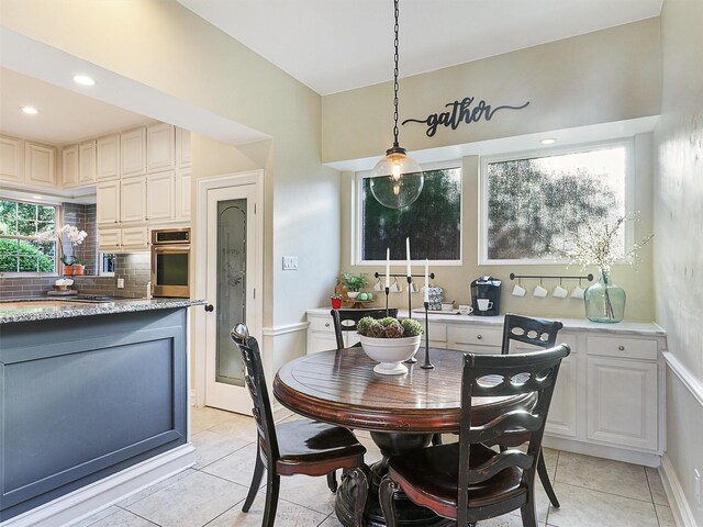 dining space featuring light tile patterned flooring