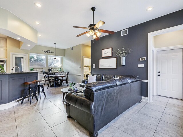 living area featuring ceiling fan, light tile patterned floors, recessed lighting, and baseboards