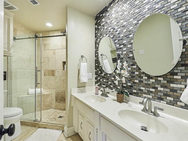 bathroom with a stall shower, toilet, tile walls, tasteful backsplash, and double vanity