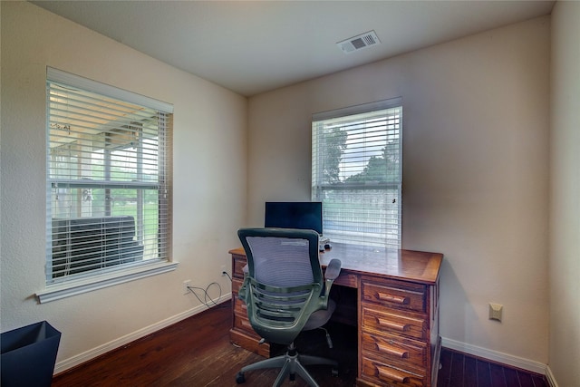 office area with baseboards, visible vents, and wood finished floors