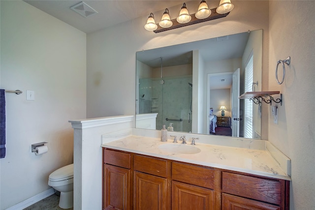 bathroom featuring visible vents, vanity, toilet, baseboards, and a shower stall