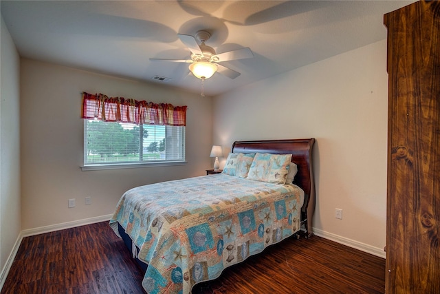 bedroom featuring ceiling fan, baseboards, visible vents, and wood finished floors