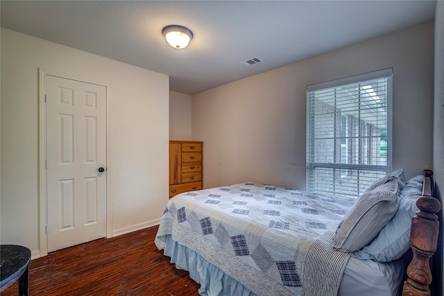 bedroom featuring baseboards, visible vents, and dark wood-style floors