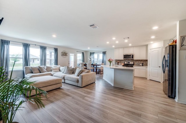 1016 Webb Ave, Aubrey, TX 76227 - living area featuring visible vents, recessed lighting, and light wood-style flooring