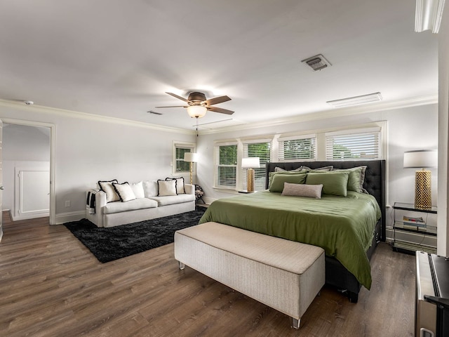 bedroom with visible vents, ornamental molding, baseboards, and dark wood-type flooring