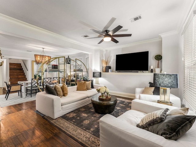 living area with ornamental molding, stairs, wood finished floors, and visible vents
