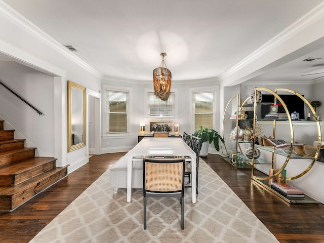 dining room with stairway, ornamental molding, wood finished floors, and visible vents