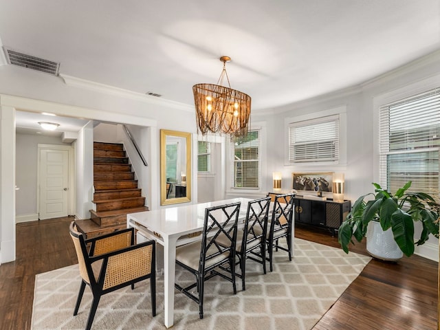 dining space featuring visible vents, ornamental molding, and light wood finished floors