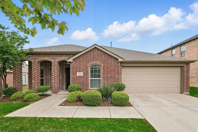 single story home with concrete driveway, brick siding, roof with shingles, and a garage
