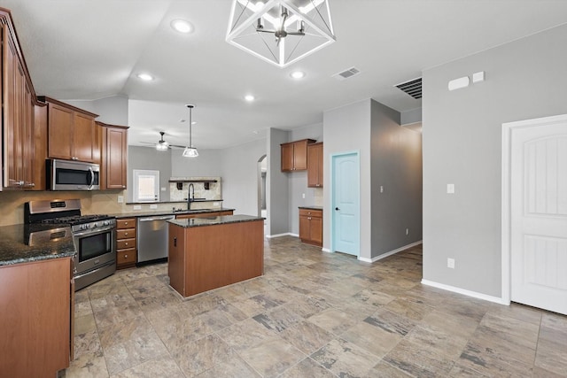 kitchen featuring a kitchen island, brown cabinetry, stainless steel appliances, and visible vents