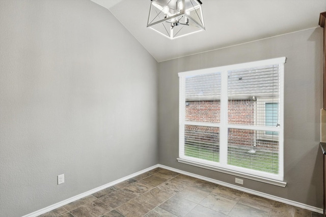 empty room featuring an inviting chandelier, baseboards, a healthy amount of sunlight, and vaulted ceiling