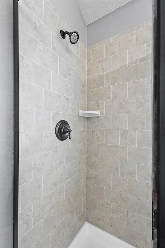 full bath featuring a tile shower