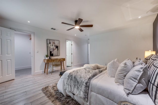 bedroom featuring visible vents, baseboards, recessed lighting, a ceiling fan, and light wood-style flooring