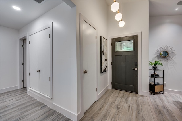 entrance foyer with recessed lighting, baseboards, and light wood-type flooring