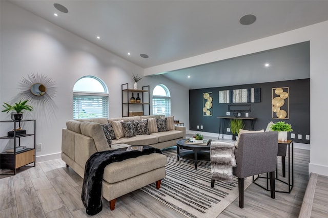 living area featuring recessed lighting, baseboards, vaulted ceiling, and light wood-type flooring