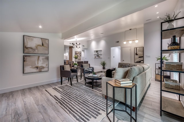 living area with recessed lighting, baseboards, and light wood finished floors