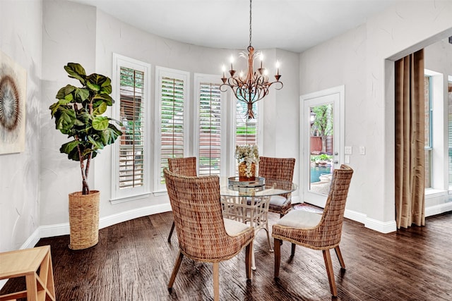 dining room featuring baseboards, wood finished floors, and a chandelier
