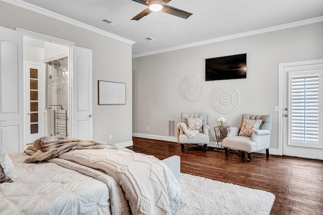 bedroom with crown molding, baseboards, wood finished floors, and visible vents