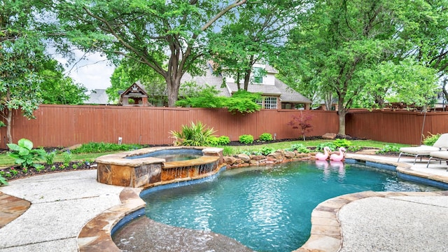 view of pool featuring an in ground hot tub, a fenced in pool, and a fenced backyard