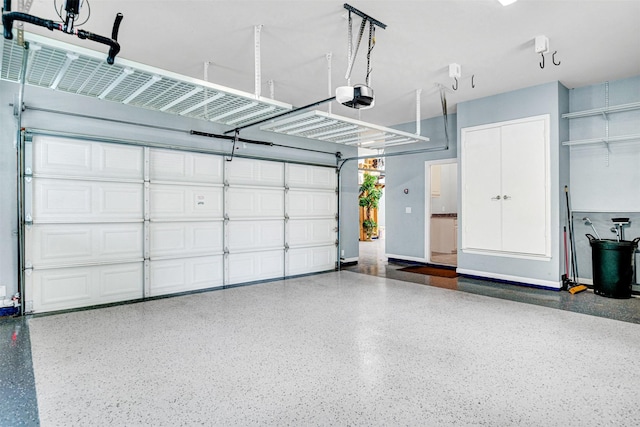 garage featuring baseboards and a garage door opener