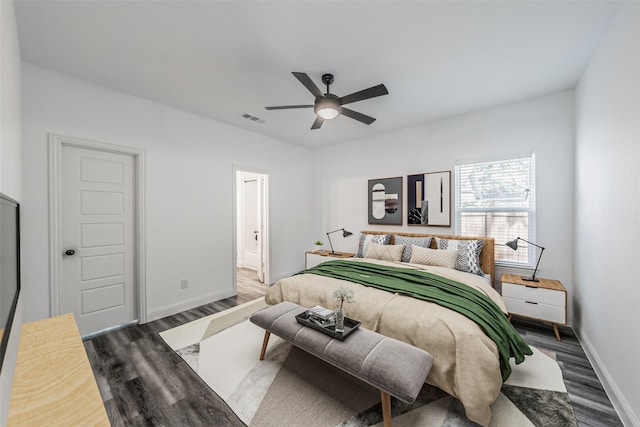 bedroom featuring connected bathroom, a ceiling fan, baseboards, visible vents, and dark wood-style floors