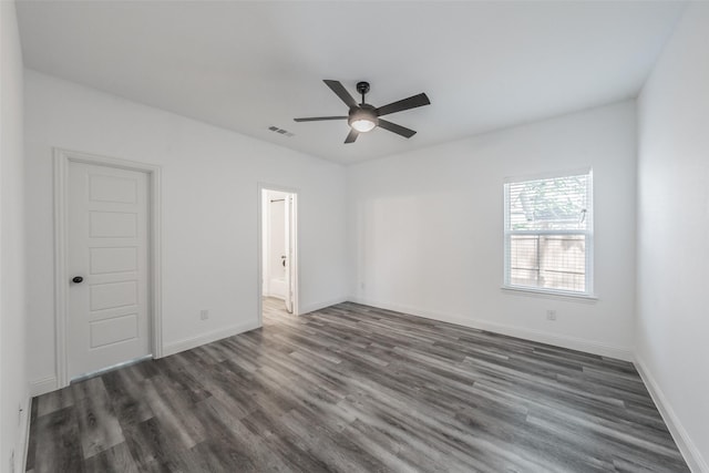 unfurnished bedroom with visible vents, a ceiling fan, dark wood finished floors, and baseboards
