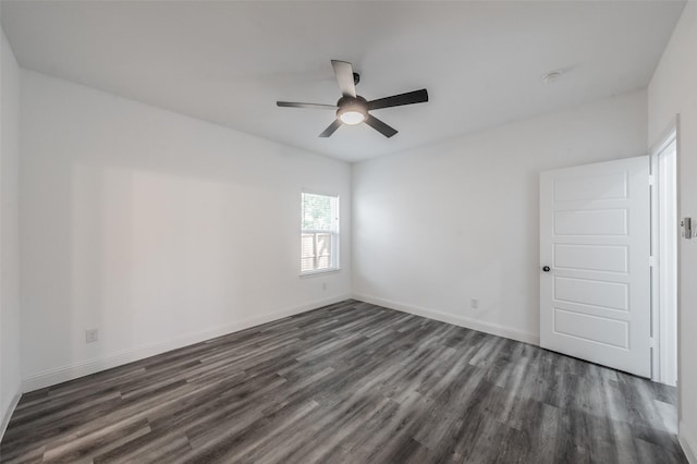 empty room with a ceiling fan, baseboards, and dark wood-style floors