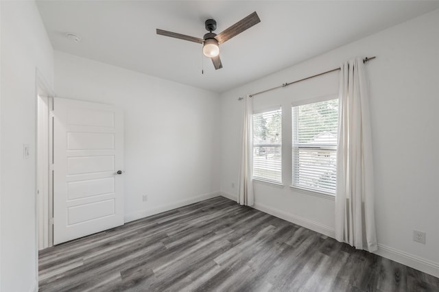 unfurnished room with a ceiling fan, baseboards, and wood finished floors