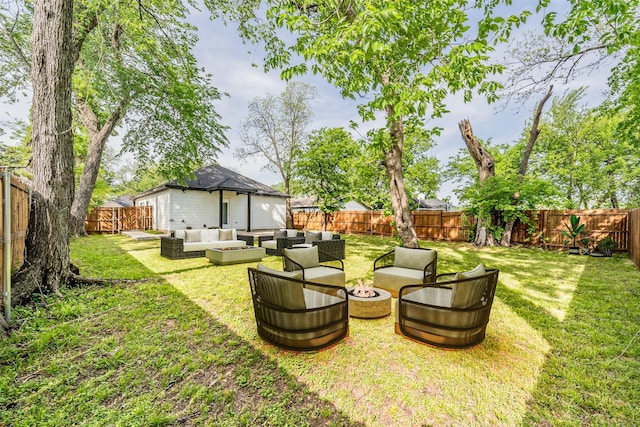view of yard featuring a fenced backyard and an outdoor living space with a fire pit