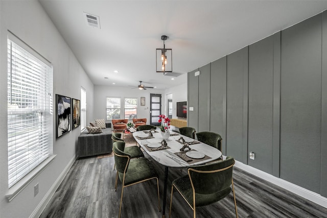 dining room with baseboards, visible vents, and dark wood-style floors