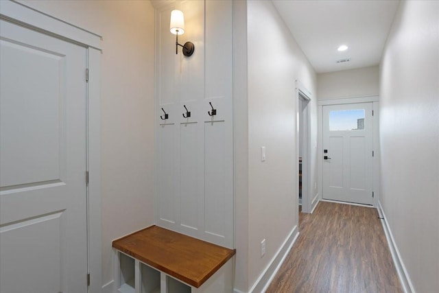 mudroom featuring baseboards, wood finished floors, and visible vents
