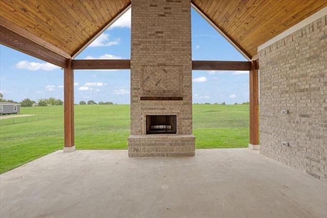 view of patio / terrace featuring a large fireplace and a rural view