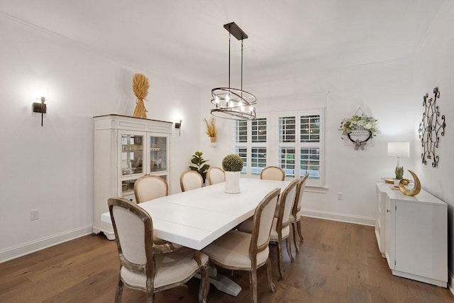 805 S Lindsay St, Gainesville, TX 76240 - dining room featuring dark wood-style floors, a chandelier, and baseboards