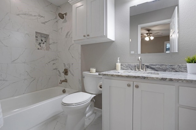 805 S Lindsay St, Gainesville, TX 76240 - full bathroom featuring toilet, tub / shower combination, marble look tile flooring, vanity, and ceiling fan
