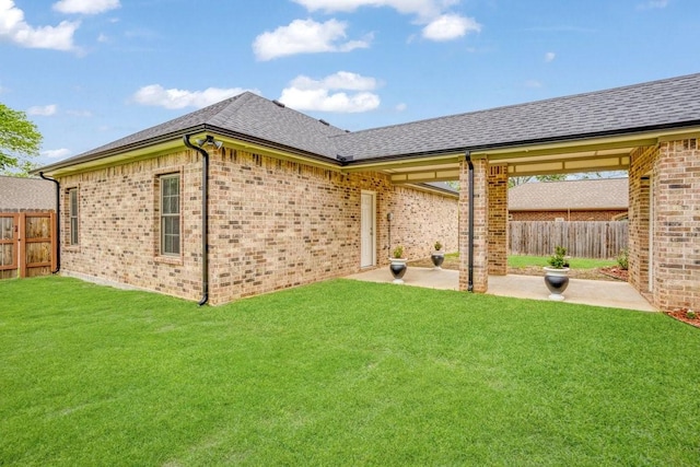 805 S Lindsay St, Gainesville, TX 76240 - rear view of property featuring a patio area, brick siding, and a shingled roof
